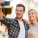 A man and a woman smile while taking a selfie